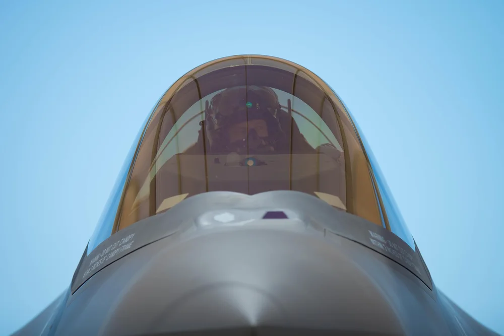 A pilot seen through the canopy of a real fighter aircraft