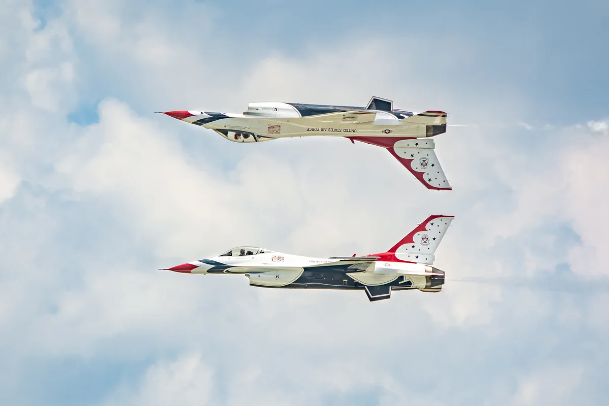 Two real Thunderbirds F-16s flying a mirrored formation